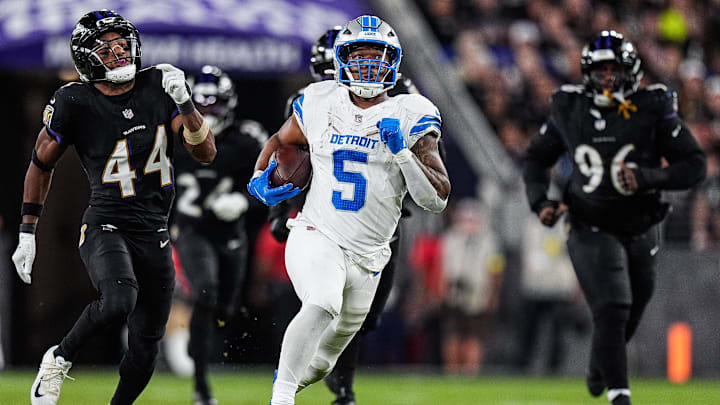 Detroit Lions running back David Montgomery (5) runs against Baltimore Ravens cornerback Marlon Humphrey (44) and defensive tackle Broderick Washington (96) during the second half at M&T Bank Stadium in Baltimore, Md. on Monday, Sept. 22, 2025.