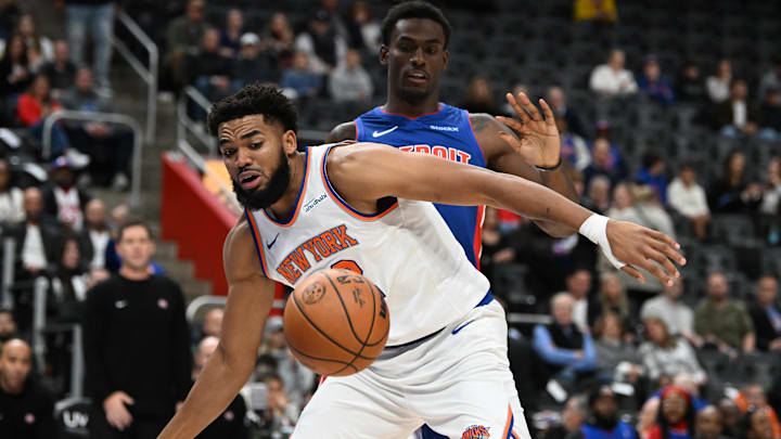 Nov 1, 2024; Detroit, Michigan, USA; New York Knicks center Karl-Anthony Towns (32) battles for a loose ball with Detroit Pistons center Jalen Duren (0) in the first quarter at Little Caesars Arena. Mandatory Credit: Lon Horwedel-Imagn Images