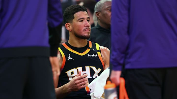 Apr 9, 2025; Phoenix, Arizona, USA; Phoenix Suns guard Devin Booker (1) reacts on the bench against the Oklahoma City Thunder during the second half at Footprint Center. Mandatory Credit: Mark J. Rebilas-Imagn Images