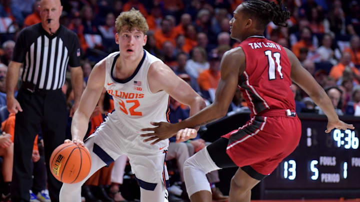 Nov 8, 2024; Champaign, Illinois, USA; Illinois Fighting Illini guard Kasparas Jakucionis (32) drives against SIU Edwardsville Cougars guard Brian Taylor II (11) during the first half at State Farm Center. Mandatory Credit: Ron Johnson-Imagn Images Nov 8, 2024; Champaign, Illinois, USA; Illinois Fighting Illini guard Kasparas Jakucionis (32) drives against SIU Edwardsville Cougars guard Brian Taylor II (11) during the first half at State Farm Center. Mandatory Credit: Ron Johnson-Imagn Images