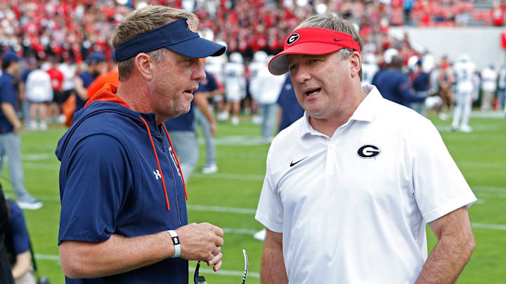 Auburn head coach Hugh Freeze speaks with Georgia head coach Kirby Smart before the start of a NCAA college football game against Auburn in Athens, Ga., on Saturday, Oct. 5, 2024.