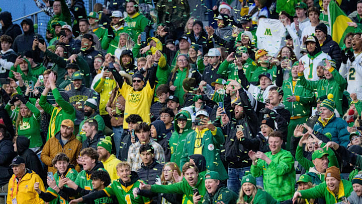 Taking over their trap: Confetti flies as Oregon fans celebrate their win in Husky Stadium, locking up a spot in the College Football Playoff.
