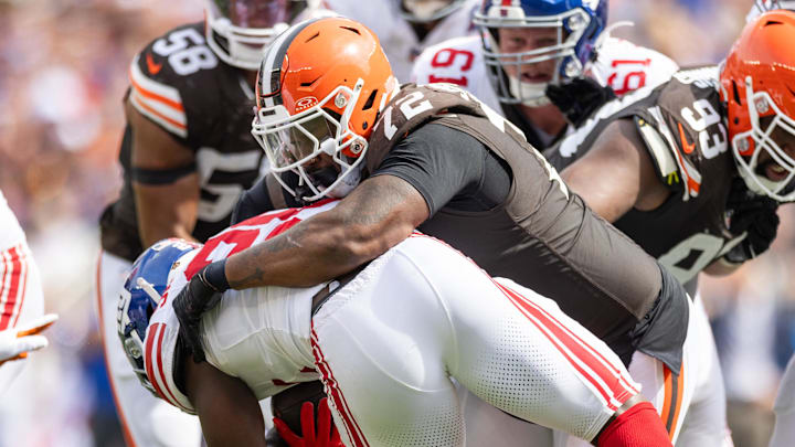 Sep 22, 2024; Cleveland, Ohio, USA; Cleveland Browns defensive tackle Quinton Jefferson (72) tackles New York Giants running back Devin Singletary (26) during the second quarter at Huntington Bank Field. Mandatory Credit: Scott Galvin-Imagn Images