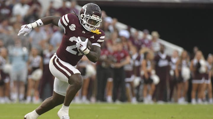 Nov 2, 2024; Starkville, Mississippi, USA; Mississippi State Bulldogs running back Davon Booth (21) runs the ball against the Massachusetts Minutemen during the third quarter at Davis Wade Stadium at Scott Field. Mandatory Credit: Matt Bush-Imagn Images