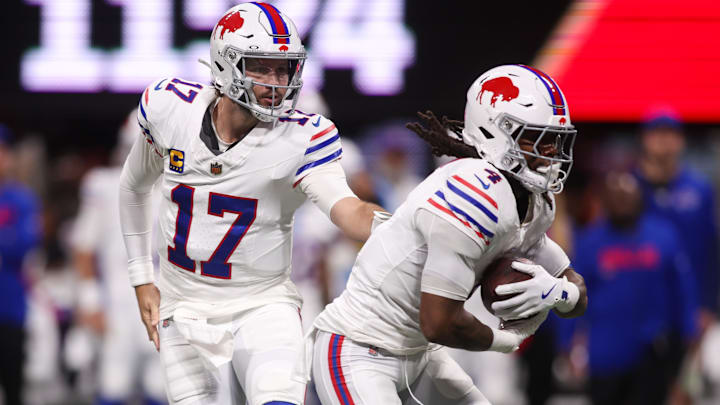 Oct 13, 2025; Atlanta, Georgia, USA; Buffalo Bills quarterback Josh Allen (17) hands off to running back James Cook (4) against the Atlanta Falcons during the first half of a game at Mercedes-Benz Stadium. 