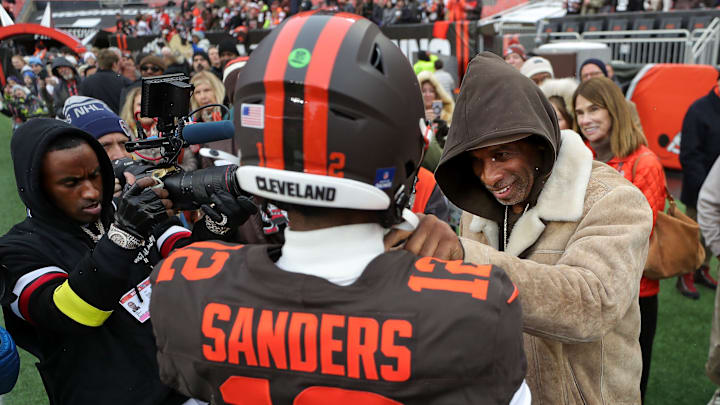 NFL legend Deion Sanders, right, gives his son Shedeur Sanders a pep talk before an NFL football game at Huntington Bank Field, Dec. 7, 2025, in Cleveland, Ohio. NFL legend Deion Sanders, right, gives his son Shedeur Sanders a pep talk before an NFL football game at Huntington Bank Field, Dec. 7, 2025, in Cleveland, Ohio.