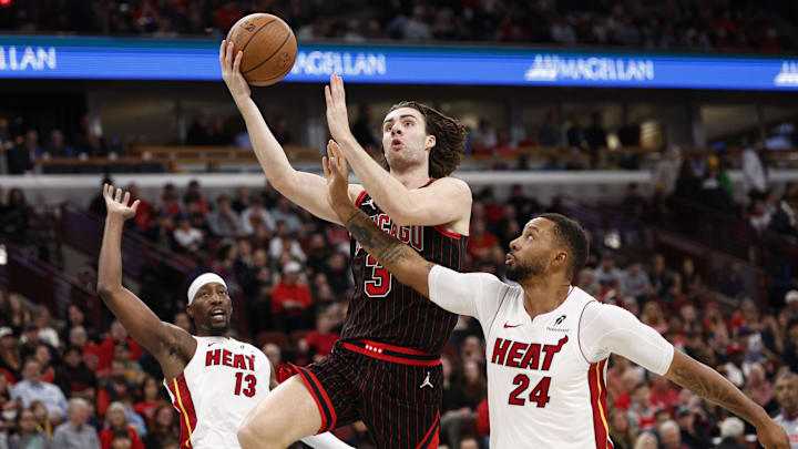 Nov 21, 2025; Chicago, Illinois, USA; Chicago Bulls guard Josh Giddey (3) drives to the basket against Miami Heat guard Norman Powell (24) during the first half at United Center. Mandatory Credit: Kamil Krzaczynski-Imagn Images