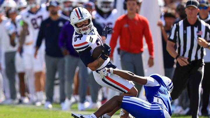 Sep 12, 2026; Provo, Utah, USA; Arizona Wildcats wide receiver Rodney Gallagher III (84) is tackled by BYU Cougars defensive back Evan Johnson (0) during the second quarter at LaVell Edwards Stadium. Sep 12, 2026; Provo, Utah, USA; Arizona Wildcats wide receiver Rodney Gallagher III (84) is tackled by BYU Cougars defensive back Evan Johnson (0) during the second quarter at LaVell Edwards Stadium.