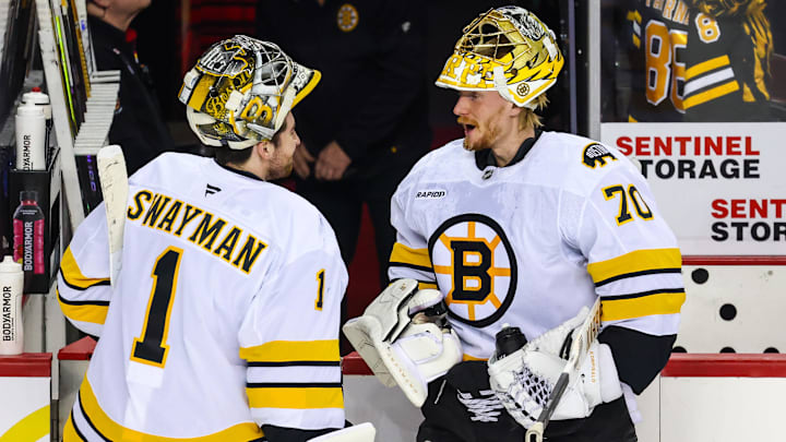 Dec 29, 2025; Calgary, Alberta, CAN; Boston Bruins goaltender Jeremy Swayman (1) and goaltender Joonas Korpisalo (70) during the warmup period against the Calgary Flames at Scotiabank Saddledome. Mandatory Credit: Sergei Belski-Imagn Images