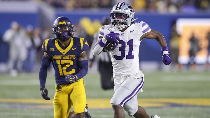 Oct 19, 2024; Morgantown, West Virginia, USA; Kansas State Wildcats running back DJ Giddens (31) runs after a catch during the third quarter against the West Virginia Mountaineers at Mountaineer Field at Milan Puskar Stadium. Mandatory Credit: Ben Queen-Imagn Images Oct 19, 2024; Morgantown, West Virginia, USA; Kansas State Wildcats running back DJ Giddens (31) runs after a catch during the third quarter against the West Virginia Mountaineers at Mountaineer Field at Milan Puskar Stadium. Mandatory Credit: Ben Queen-Imagn Images