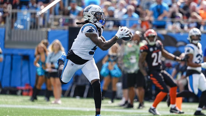 Sep 29, 2024; Charlotte, North Carolina, USA;  Carolina Panthers wide receiver Diontae Johnson (5) catches a pass from quarterback Andy Dalton (14) for a touchdown during the third quarter at Bank of America Stadium. Mandatory Credit: Jim Dedmon-Imagn Images