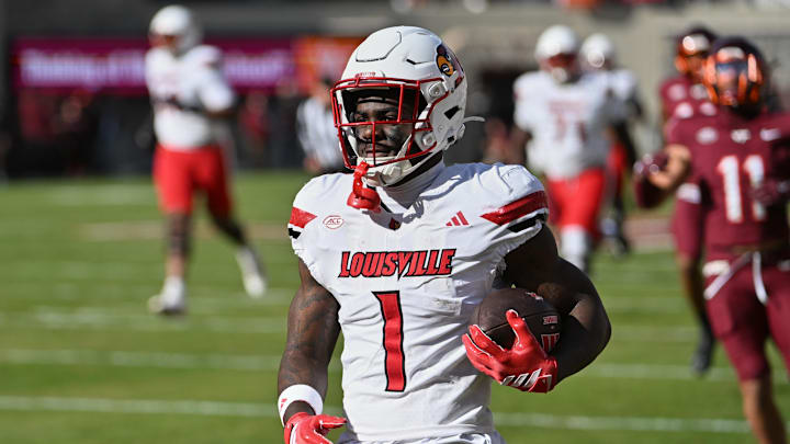 Nov 1, 2025; Blacksburg, Virginia, USA;  Louisville Cardinals running back Isaac Brown (1) reacts after scoring a touchdown against the Virginia Tech Hokies during the first quarter at Lane Stadium. Mandatory Credit: Brian Bishop-Imagn Images