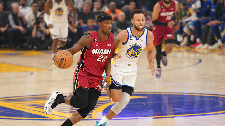 Oct 27, 2022; San Francisco, California, USA; Miami Heat forward Jimmy Butler (22) dribbles past Golden State Warriors guard Stephen Curry (30) in the first quarter at the Chase Center. Mandatory Credit: Cary Edmondson-Imagn Images