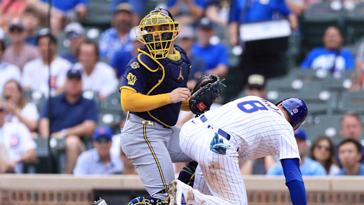William Contreras and Ian Happ collide at the plate during a Chicago Cubs vs. Milwaukee Brewers game.