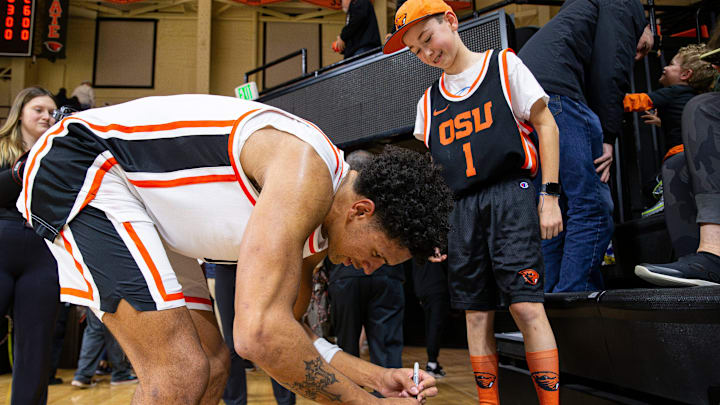 Oregon State's Michael Rataj (12) signs an arm sleeve for Parker Hune, 11, after defeating San Diego at Gill Coliseum on Saturday, Jan. 4, 2025, in Corvallis, Ore. Oregon State's Michael Rataj (12) signs an arm sleeve for Parker Hune, 11, after defeating San Diego at Gill Coliseum on Saturday, Jan. 4, 2025, in Corvallis, Ore.