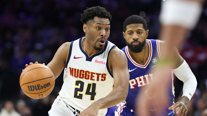 Jan 5, 2026; Philadelphia, Pennsylvania, USA; Denver Nuggets guard Jalen Pickett (24) drives past Philadelphia 76ers forward Paul George (8) during the fourth quarter at Xfinity Mobile Arena.