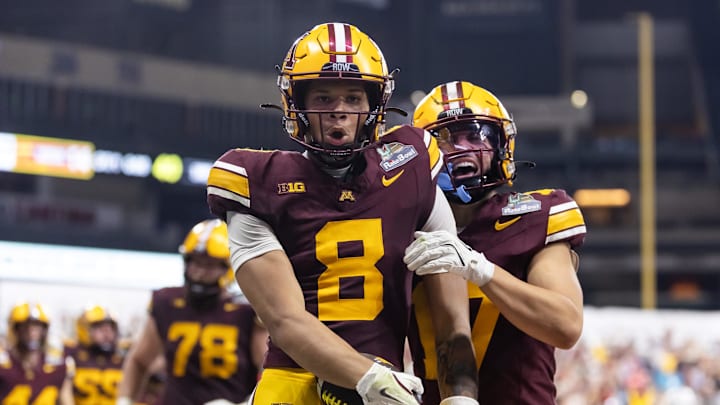 Dec 26, 2025; Phoenix, AZ, USA; Minnesota Gophers wide receiver Jalen Smith (8) celebrates with teammate Logan Loya (17) after catching the game winning touchdown pass against the New Mexico Lobos during overtime of the Rate Bowl at Chase Field. Mandatory Credit: Mark J. Rebilas-Imagn Images