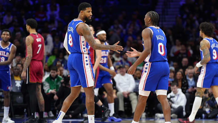 Feb 5, 2025; Philadelphia, Pennsylvania, USA; Philadelphia 76ers forward Paul George (8) reacts with guard Tyrese Maxey (0) against the Miami Heat in the first quarter at Wells Fargo Center.