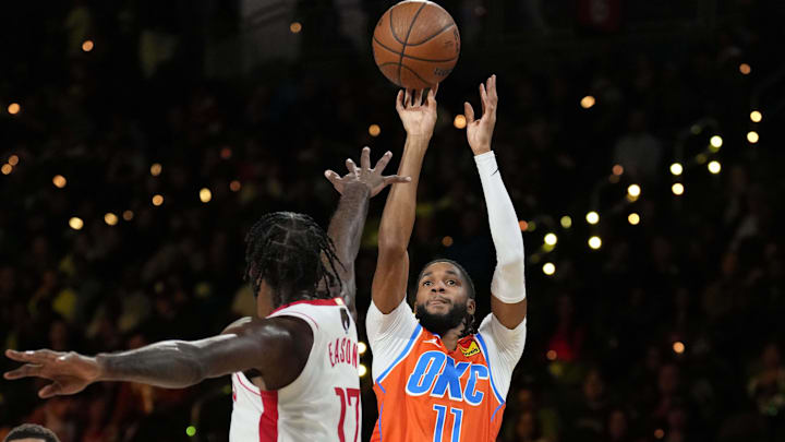 Dec 14, 2024; Las Vegas, Nevada, USA; Oklahoma City Thunder guard Isaiah Joe (11) shoots against Houston Rockets forward Tari Eason (17) during the first half in a semifinal of the 2024 Emirates NBA Cup at T-Mobile Arena. Mandatory Credit: Kyle Terada-Imagn Images