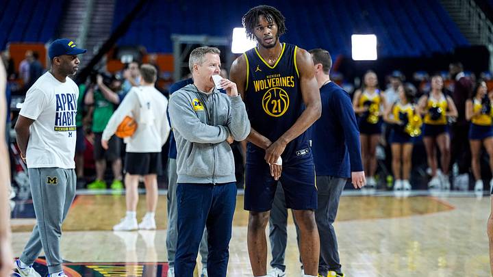 Michigan head coach Dusty May talks to forward Morez Johnson Jr. (21) at open practice at Lucas Oil Stadium in Indianapolis on Friday, April 3, 2026.