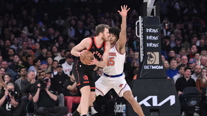 Dec 11, 2023; New York, New York, USA; Toronto Raptors center Jakob Poeltl (19) looks to post up while being defended by New York Knicks center Jericho Sims (45) during the first quarter at Madison Square Garden. Mandatory Credit: John Jones-Imagn Images