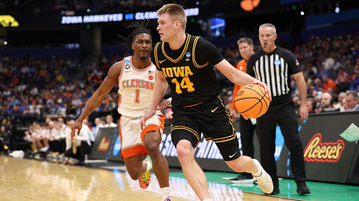 Mar 20, 2026; Tampa, FL, USA; Iowa Hawkeyes guard Bennett Stirtz (14) moves the ball while defended by Clemson Tigers guard Jestin Porter (1) in the first half  during a first round game of the men's 2026 NCAA Tournament at Benchmark International Arena. Mandatory Credit: Nathan Ray Seebeck-Imagn Images