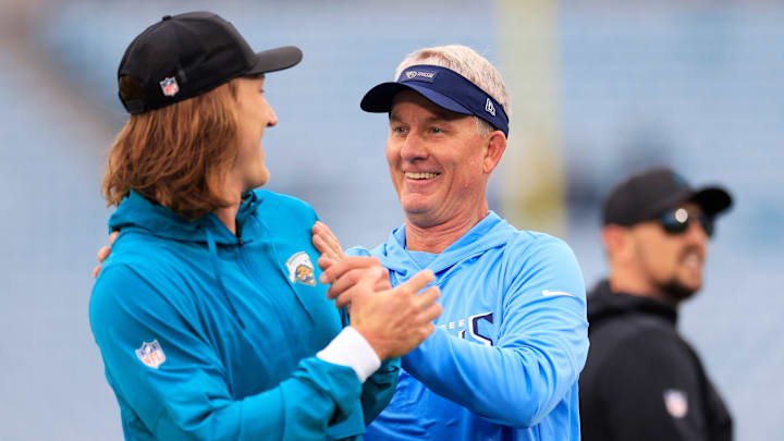Jacksonville Jaguars quarterback Trevor Lawrence (16), left, is surprised by Tennessee Titans head coach Mike McCoy before an NFL football matchup at EverBank Stadium, Sunday, Jan. 4, 2026, in Jacksonville, Fla. [Corey Perrine/Florida Times-Union]