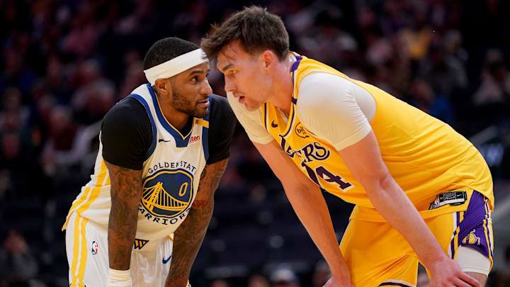 Oct 18, 2024; San Francisco, California, USA; Golden State Warriors guard Gary Payton II (0) stands next to Los Angeles Lakers center Colin Castleton (14) in the third quarter at the Chase Center. Mandatory Credit: Cary Edmondson-Imagn Images

