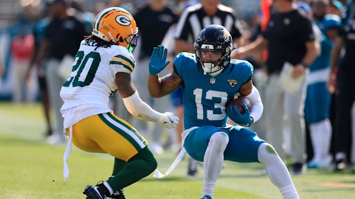 Jacksonville Jaguars wide receiver Christian Kirk (13) tries to manuver past Green Bay Packers safety Javon Bullard (20) during the third quarter of an NFL football matchup Sunday, Oct. 27, 2024 at EverBank Stadium in Jacksonville, Fla. The Packers edged the Jaguars 30-27 on a last-second field goal. [Corey Perrine/Florida Times-Union]