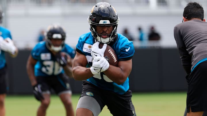 Jacksonville Jaguars running back Bhayshul Tuten (33) runs the ball during a rookie minicamp at Miller Electric Center Saturday, May 10, 2025 in Jacksonville, Fla. [Corey Perrine/Florida Times-Union]