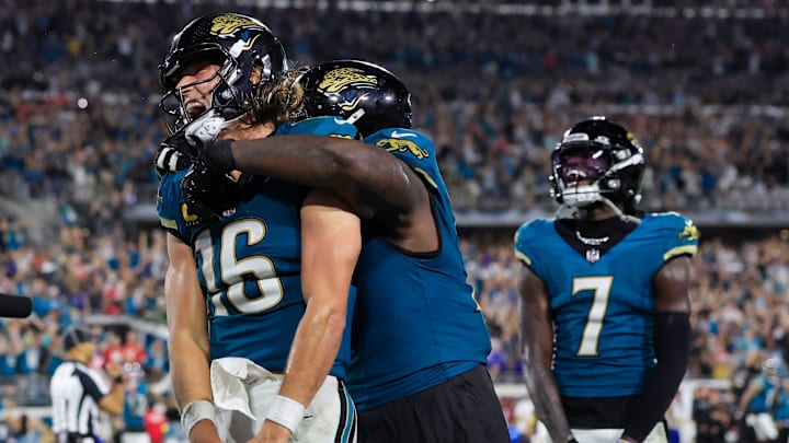 Jacksonville Jaguars quarterback Trevor Lawrence (16) celebrates his game-winning touchdown score letting out a yell with offensive tackle Anton Harrison (77) hanging on his shoulders during the fourth quarter of an NFL football matchup at EverBank Stadium, Monday, Oct. 6, 2025, in Jacksonville, Fla. The Jacksonville Jaguars edged the Kansas City Chiefs 31-28. [Corey Perrine/Florida Times-Union]