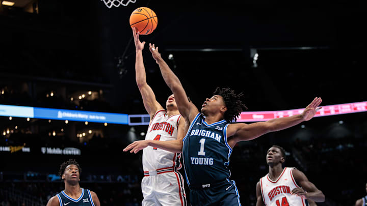 Mar 12, 2026; Kansas City, MO, USA; Houston Cougars guard Kingston Flemings (4) shoots the ball around BYU Cougars guard Robert Wright III (1) during the first half at T-Mobile Center. 