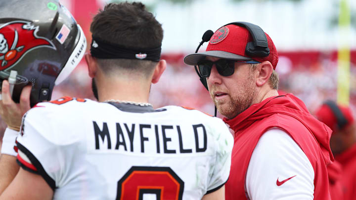 Sep 8, 2024; Tampa, Florida, USA;  Tampa Bay Buccaneers quarterback Baker Mayfield (6) talks with offensive coordinator Liam Coen against the Washington Commanders during the first half at Raymond James Stadium. Mandatory Credit: Kim Klement Neitzel-Imagn Images