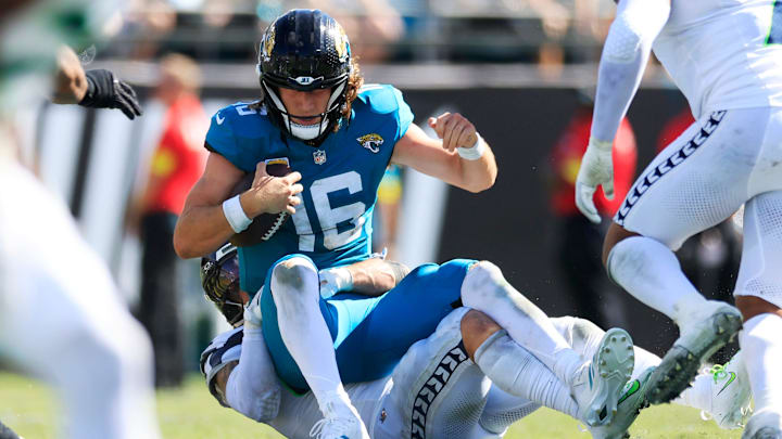 Jacksonville Jaguars quarterback Trevor Lawrence (16) is sacked by Seattle Seahawks linebacker Drake Thomas (42) during the third quarter of an NFL football matchup, Sunday, Oct. 12, 2025, at EverBank Stadium in Jacksonville, Fla. The Seahawks defeated the Jaguars 20-12.
