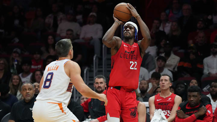 Dec 7, 2024; Miami, Florida, USA;  Miami Heat forward Jimmy Butler (22) shoots the ball against Phoenix Suns guard Grayson Allen (8) during the second half at Kaseya Center. Mandatory Credit: Jim Rassol-Imagn Images