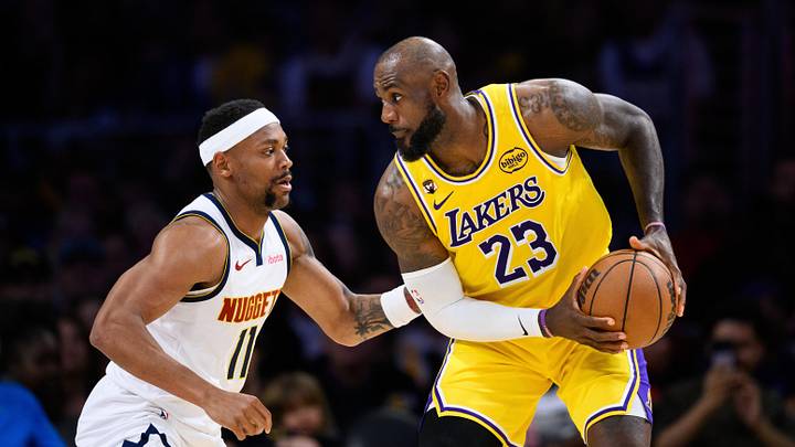 Mar 14, 2026; Los Angeles, California, USA; Los Angeles Lakers forward LeBron James (23) controls the ball while under pressure from Denver Nuggets guard Bruce Brown (11) during the second half at Crypto.com Arena.