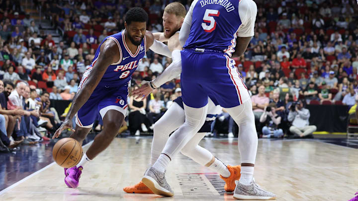 Oct 11, 2024; Des Moines, Iowa, USA; Philadelphia 76ers center Andre Drummond (5) screens Minnesota Timberwolves guard Donte DiVincenzo (0), as Philadelphia 76ers forward Paul George (8) drives to the basket at Wells Fargo Arena. Mandatory Credit: Reese Strickland-Imagn Images