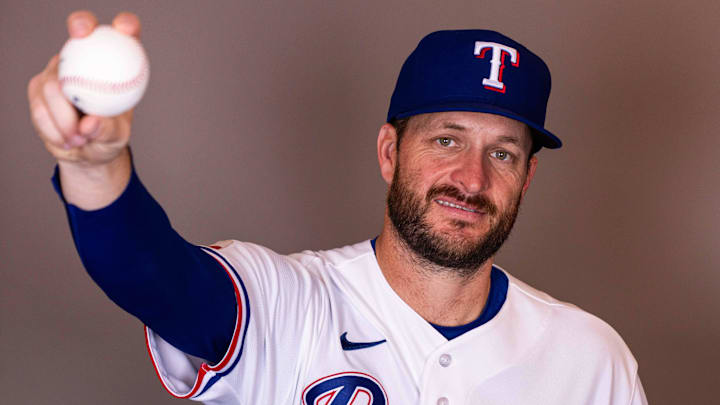 Texas Rangers pitcher Ryan Brasier poses with a baseball for a photo.