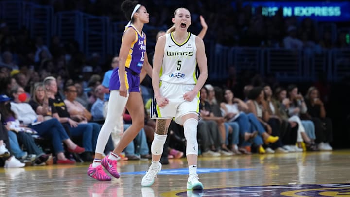 Aug 20, 2025; Los Angeles, California, USA; Dallas Wings guard Paige Bueckers (5) celebrates in the second half as LA Sparks guard Rae Burrell (12) watches at Crypto.com Arena. Mandatory Credit: Kirby Lee-Imagn Images Aug 20, 2025; Los Angeles, California, USA; Dallas Wings guard Paige Bueckers (5) celebrates in the second half as LA Sparks guard Rae Burrell (12) watches at Crypto.com Arena. Mandatory Credit: Kirby Lee-Imagn Images