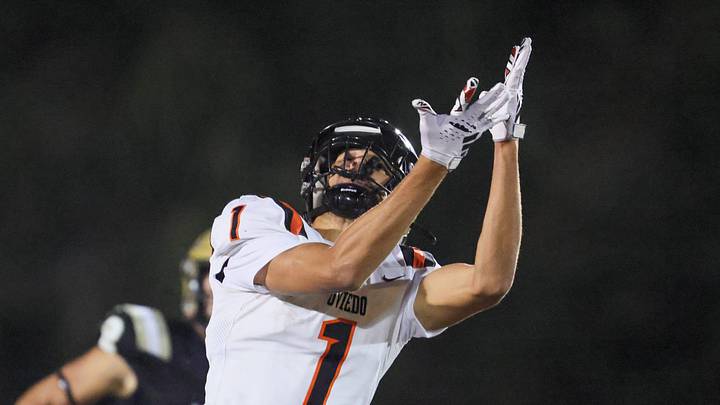 Oviedo Jordan Donahoo (1) tries to catch the pass under pressure from Oviedo Bruce Slivinski (5) during the 2025 FHSAA Football 6A quarter final at Citizens Field in Gainesville, FL on Thursday, November 13, 2025. [Alan Youngblood/Gainesville Sun]