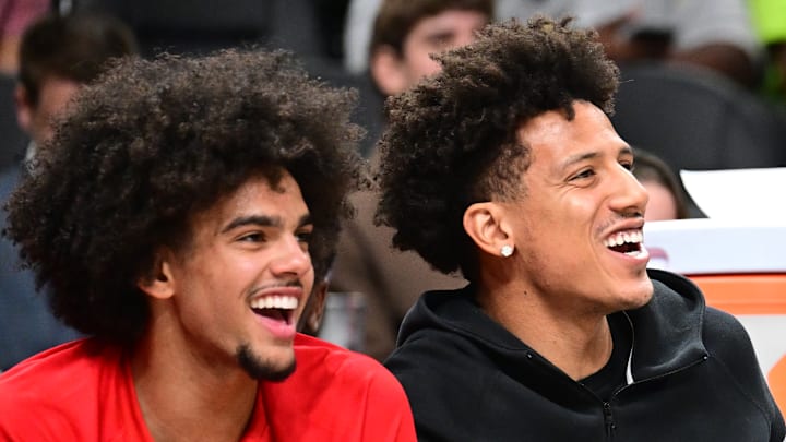 Asa Newell and Jalen Johnson laugh on the bench against the Miami Heat