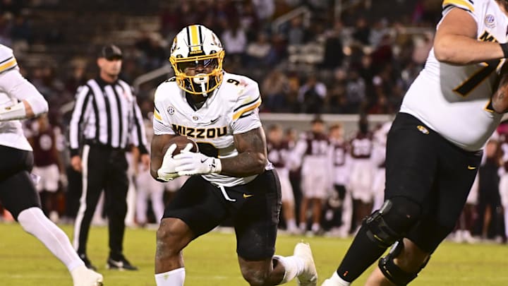 Nov 23, 2024; Starkville, Mississippi, USA;  Missouri Tigers running back Marcus Carroll (9) runs against the Mississippi State Bulldogs during the fourth quarter at Davis Wade Stadium at Scott Field. Mandatory Credit: Matt Bush-Imagn Images