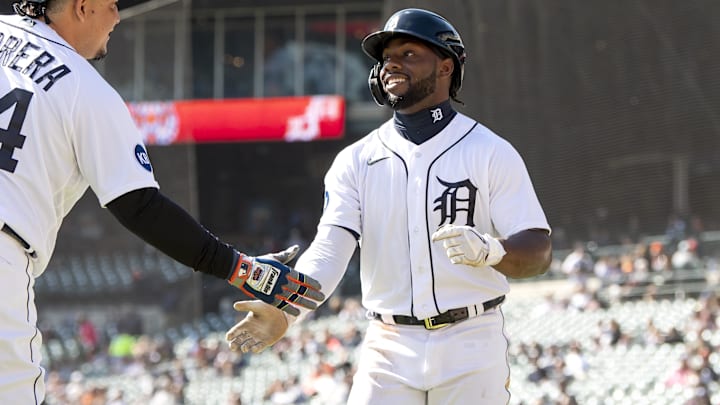 Detroit Tigers left fielder Akil Baddoo (60) (right) celebrates after crossing home plate.