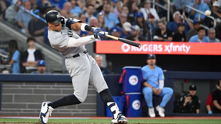 Jul 23, 2025; Toronto, Ontario, CAN;  New York Yankees designated hitter Aaron Judge (99) hits a two run home run against the Toronto Blue Jays in the sixth inning at Rogers Centre. Mandatory Credit: Dan Hamilton-Imagn Images