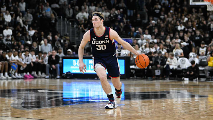Mar 1, 2025; Providence, Rhode Island, USA; Connecticut Huskies forward Liam McNeeley (30) dribbles against the Providence Friars  during the second half at Amica Mutual Pavilion. Mandatory Credit: Eric Canha-Imagn Images