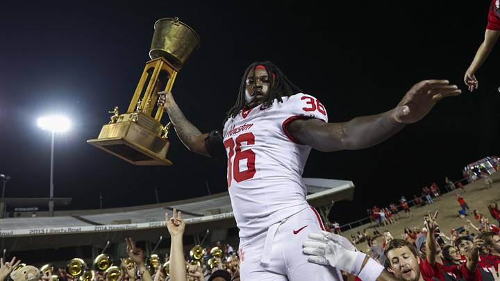 Sep 6, 2025; Houston, Texas, USA; Houston Cougars linebacker Jalen Garner (36) raises the Bayou Bucket trophy after a win against the Rice Owls at Rice Stadium. Mandatory Credit: Troy Taormina-Imagn Images Sep 6, 2025; Houston, Texas, USA; Houston Cougars linebacker Jalen Garner (36) raises the Bayou Bucket trophy after a win against the Rice Owls at Rice Stadium. Mandatory Credit: Troy Taormina-Imagn Images