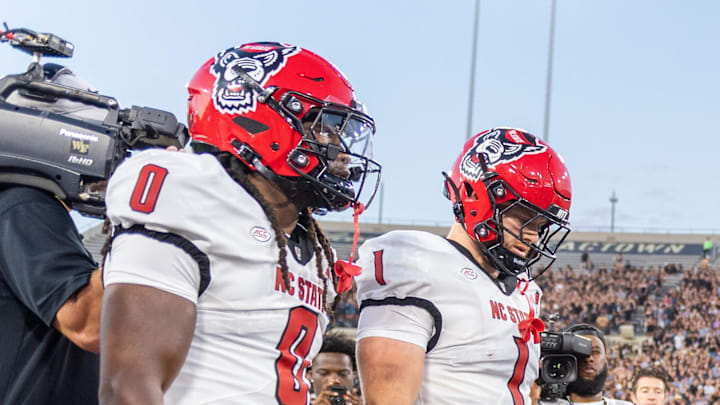 Sep 11, 2025; Winston-Salem, North Carolina, USA;  North Carolina State Wolfpack win the coin toss against the Wake Forest Demon Deacons at Allegacy Federal Credit Union Stadium. Mandatory Credit: Luke Jamroz-Imagn Images