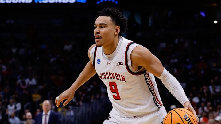 Mar 20, 2025; Denver, CO, USA; Wisconsin Badgers guard John Tonje (9) dribbles the ball against the Montana Grizzlies during the first half in the first round of the NCAA Tournament at Ball Arena. Mandatory Credit: Isaiah J. Downing-Imagn Images