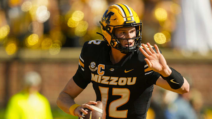 Oct 19, 2024; Columbia, Missouri, USA; Missouri Tigers quarterback Brady Cook (12) rolls out to pass during the second half against the Auburn Tigers at Faurot Field at Memorial Stadium. Mandatory Credit: Jay Biggerstaff-Imagn Images
