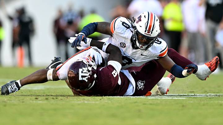 Sep 27, 2025; College Station, Texas, USA; Auburn Tigers linebacker Robert Woodyard Jr. (0) wraps up Texas A&M Aggies running back Le'Veon Moss (8) during the third quarter at Kyle Field. Mandatory Credit: Maria Lysaker-Imagn Images Sep 27, 2025; College Station, Texas, USA; Auburn Tigers linebacker Robert Woodyard Jr. (0) wraps up Texas A&M Aggies running back Le'Veon Moss (8) during the third quarter at Kyle Field. Mandatory Credit: Maria Lysaker-Imagn Images